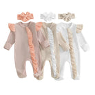 Three baby rompers with ruffled sleeves and legs, accompanied by three hair bows, on a light green background.