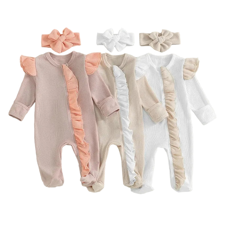 Three baby rompers with ruffled sleeves and legs, accompanied by three hair bows, on a light green background.